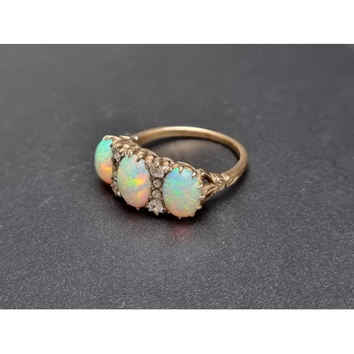 174 - A yellow metal ring, set three cabochon opals and eight graduated mine cut diamonds, size O.... 