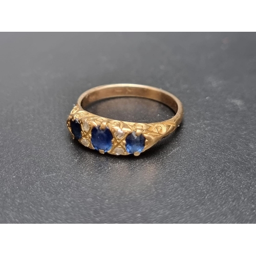 176 - A Victorian yellow metal ring, set three oval sapphires and four diamond chips, size N 1/2.... 