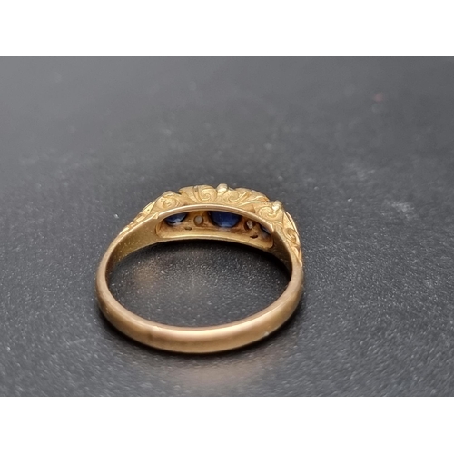 176 - A Victorian yellow metal ring, set three oval sapphires and four diamond chips, size N 1/2.... 