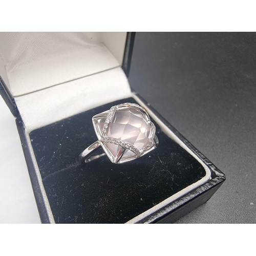 177 - A 9k white gold ring, set rose quartz with four strands of diamonds, size N, gross weight 3g.... 