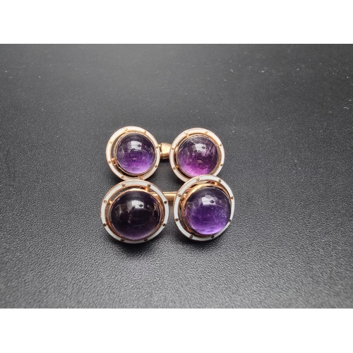 201 - An unusual pair of yellow metal and white enamel cufflinks, set cabochon amethyst.