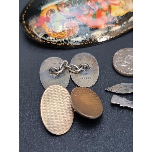 209 - A pair of white metal kukri cufflinks, having chain link connectors; together with a pair of oval en... 