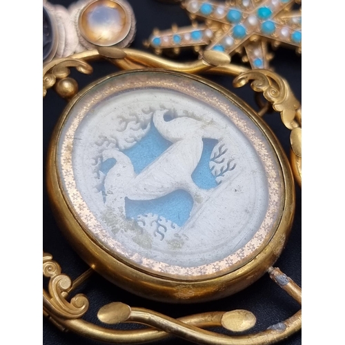 220 - A Victorian intaglio brooch, set with a facetted semi precious gemstone to each side, 45mm; together... 