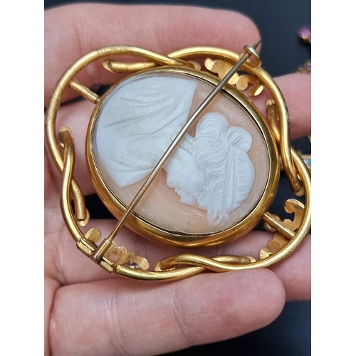 220 - A Victorian intaglio brooch, set with a facetted semi precious gemstone to each side, 45mm; together... 