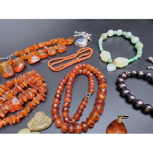 221 - A 'cherry amber' graduated and facetted bead necklace, 47cm long; together with three amber necklace... 