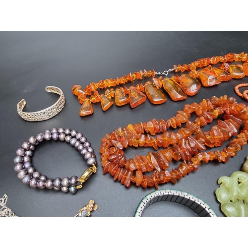 221 - A 'cherry amber' graduated and facetted bead necklace, 47cm long; together with three amber necklace... 