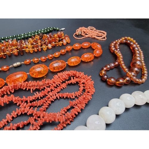 222 - An amber necklace, having clasp stamped '925 Sterling', 81cm; together with two coral necklaces; fou... 