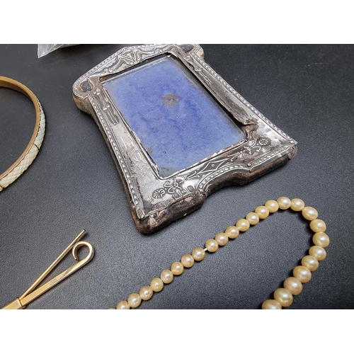 223 - A small silver photograph frame; together with a quantity of costume jewellery and cufflinks.... 