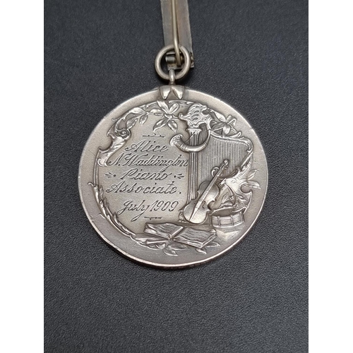 312 - A London College of Music silver medal, to Alice Waddington... 1909, 4.3cm diameter, 38g.... 