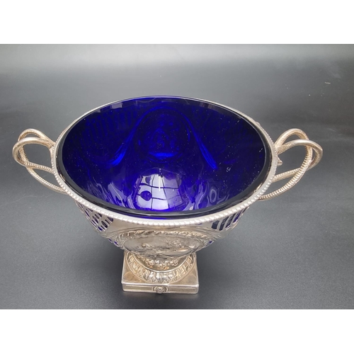 52 - A George III silver footed bowl, having entwined snake handles, with pierced and embossed decoration... 