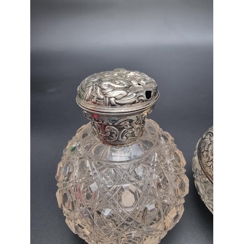 67 - Two silver mounted cut glass scent bottles; together with a silver lidded cut glass preserve jar; a ... 