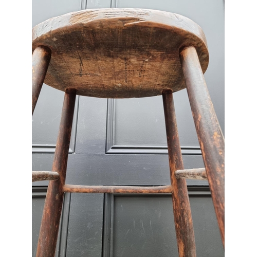 1017 - An old elm top high stool, 69cm high.