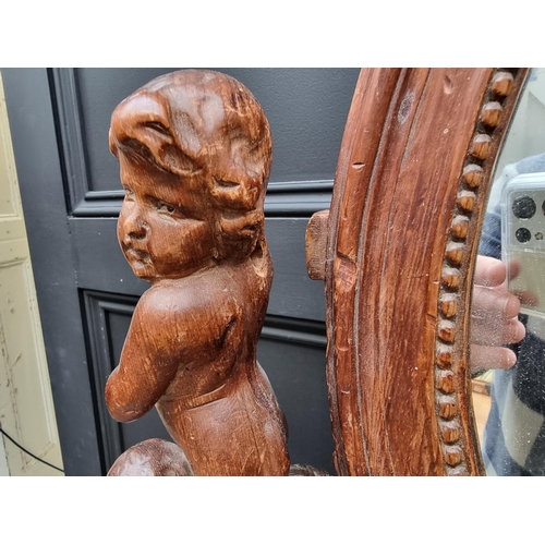 1346 - An antique Continental carved pine dressing table mirror, 79cm high, (damage and losses).... 