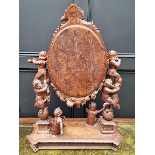 1346 - An antique Continental carved pine dressing table mirror, 79cm high, (damage and losses).... 