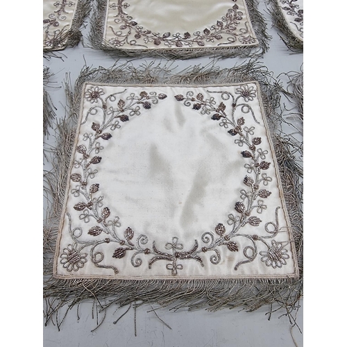 1402 - A set of six metal thread embroidered silk doilies.