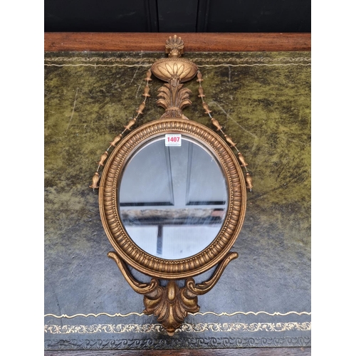 1407 - A small neo-classical style gilt framed wall mirror, 60cm long. 