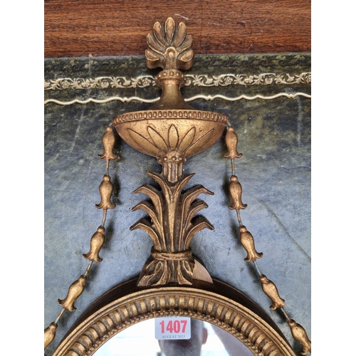 1407 - A small neo-classical style gilt framed wall mirror, 60cm long. 