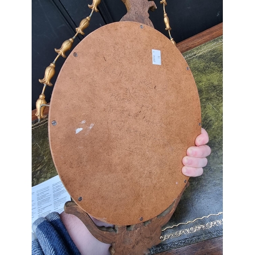 1407 - A small neo-classical style gilt framed wall mirror, 60cm long. 