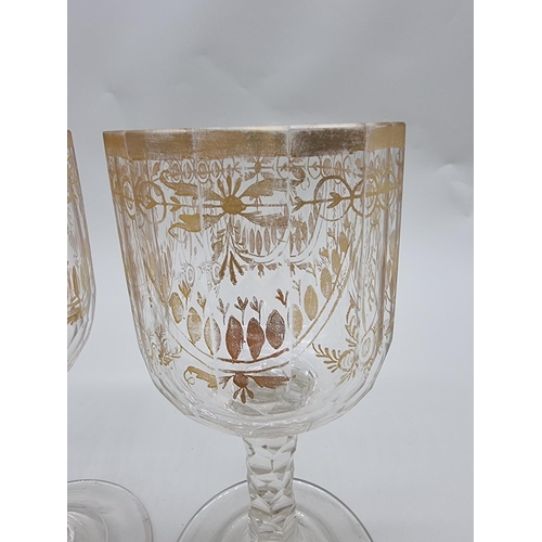 1509 - A pair of antique clear and cut glass goblets, with facetted stems, 19cm high.