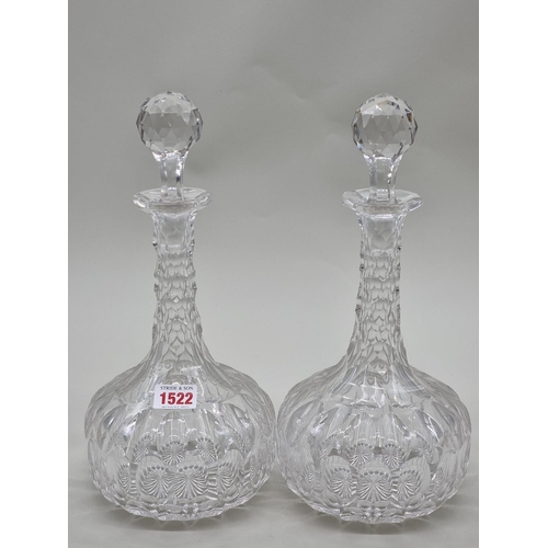 1522 - A good pair of cut glass decanters and stoppers, 31cm high.