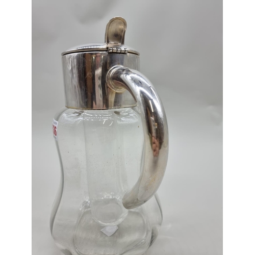 1536 - An electroplated clear glass lemonade jug and liner, 28cm high.