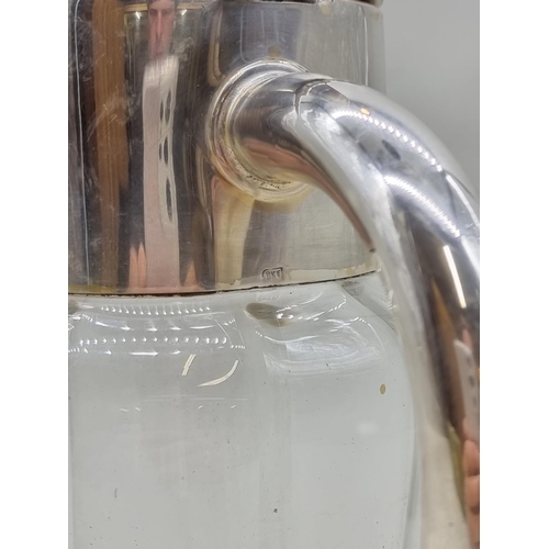 1536 - An electroplated clear glass lemonade jug and liner, 28cm high.