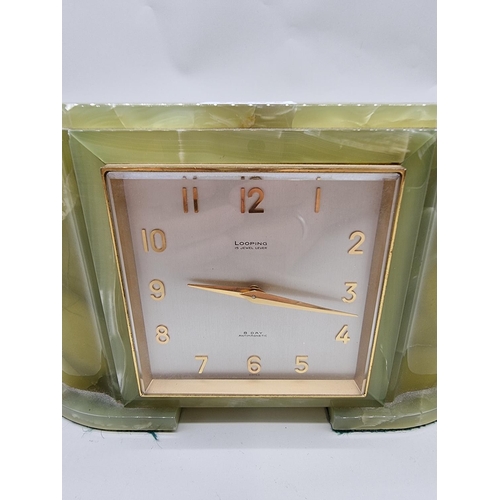 1537 - A green onyx mantel timepiece, the dial inscribed 'Looping', 21.5cm wide.