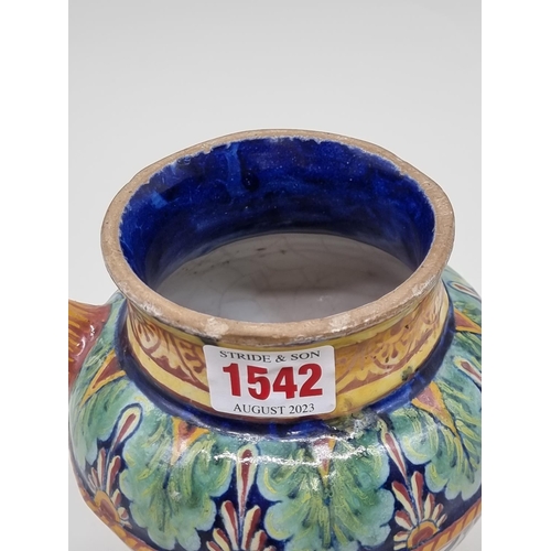 1542 - An Italian maiolica drug jar, 17.5cm high, (chips).