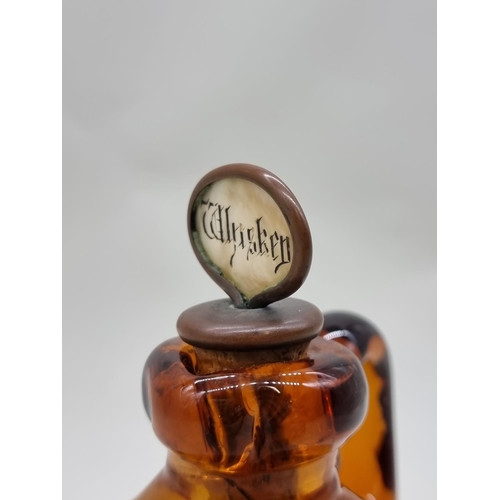 1543 - A Victorian amber glass whisky jug and mother of pearl stopper, with etched registration lozenge, he... 