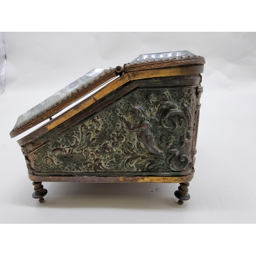 1548 - A Continental brass and glass casket, 14.5cm wide; together with a plated metal inkwell, 24cm wide.... 