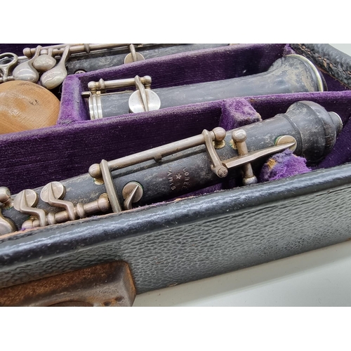 1569 - An F Loree oboe, in three parts, 58.4cm long, in fitted case.