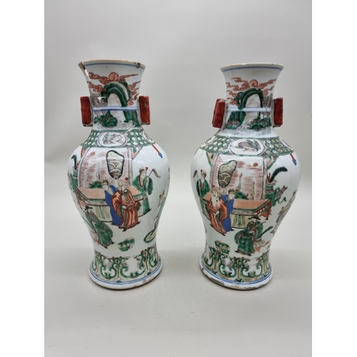 1602 - A large pair of Chinese famille verte twin handled vases, Qing, 36cm high, (s.d).