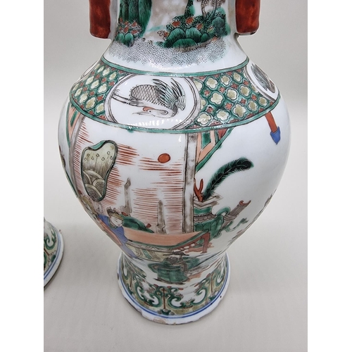 1602 - A large pair of Chinese famille verte twin handled vases, Qing, 36cm high, (s.d).