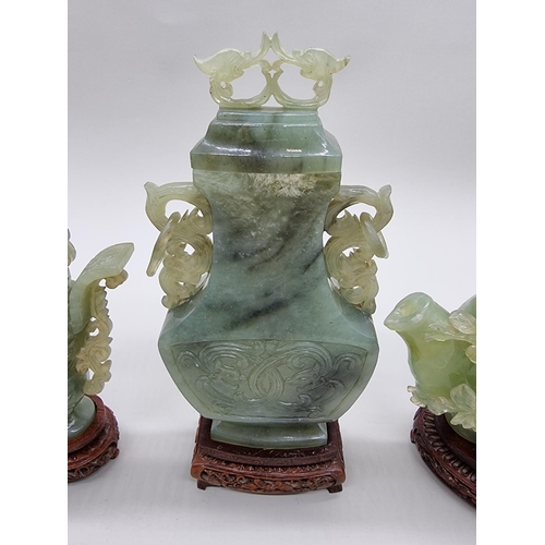 1604 - Three Chinese carved green jade twin handled vases and covers, 22cm high; together with another... 