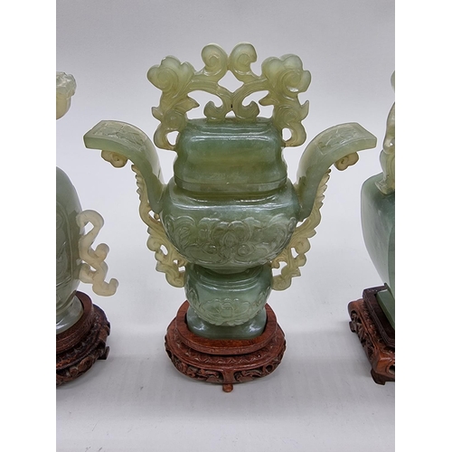 1604 - Three Chinese carved green jade twin handled vases and covers, 22cm high; together with another... 