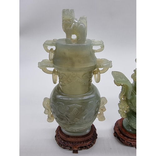 1604 - Three Chinese carved green jade twin handled vases and covers, 22cm high; together with another... 