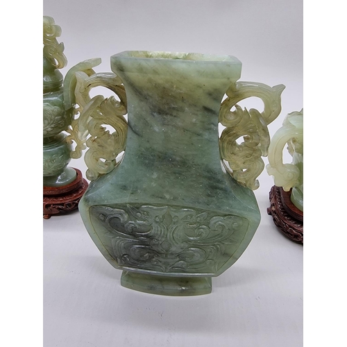 1604 - Three Chinese carved green jade twin handled vases and covers, 22cm high; together with another... 