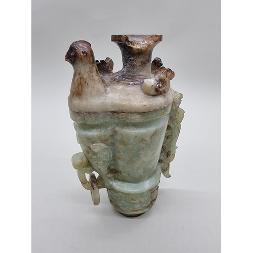 1605 - A Chinese Archaistic style carved green and russet jade ewer and cover, 22cm high, (chips to co... 