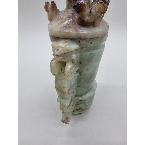 1605 - A Chinese Archaistic style carved green and russet jade ewer and cover, 22cm high, (chips to co... 