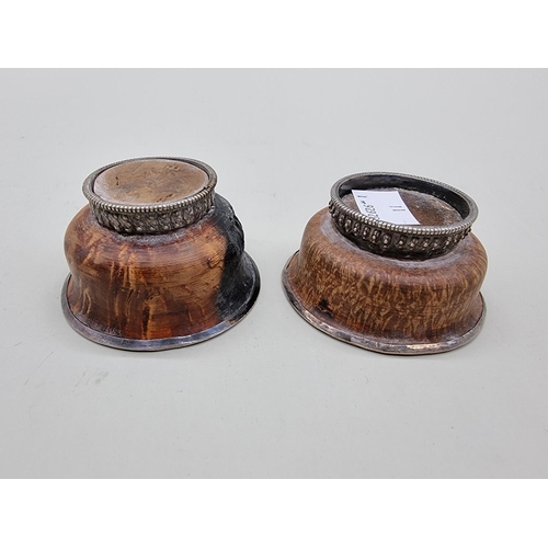 1606 - A small pair of burr wood and white metal mounted bowls, 7cm diameter. 