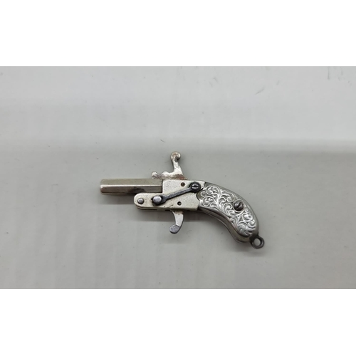 1626 - An antique nickel plated miniature novelty pistol, 4cm.