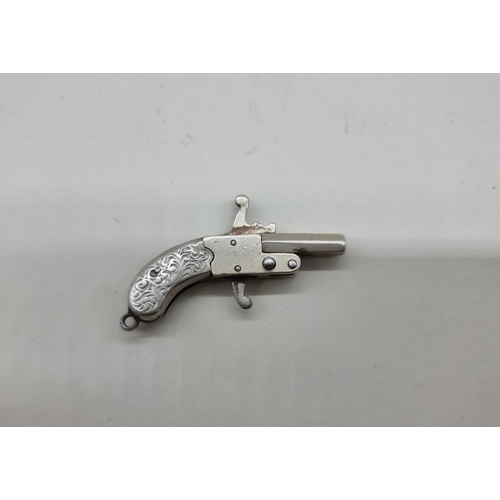 1626 - An antique nickel plated miniature novelty pistol, 4cm.