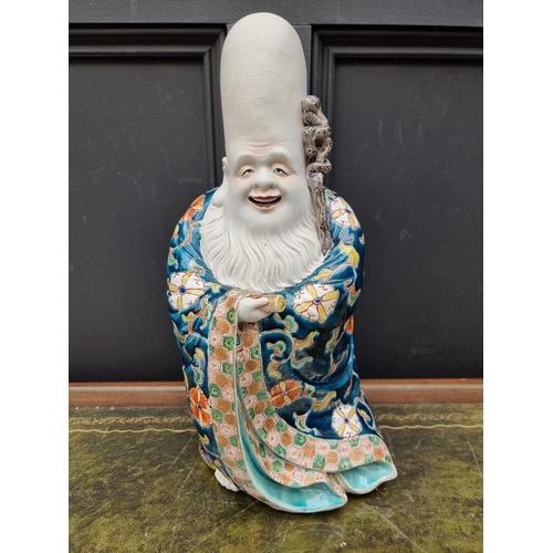 1671 - A large Japanese Kutani porcelain figure of Fukurokuju, 39cm high, (s.d).