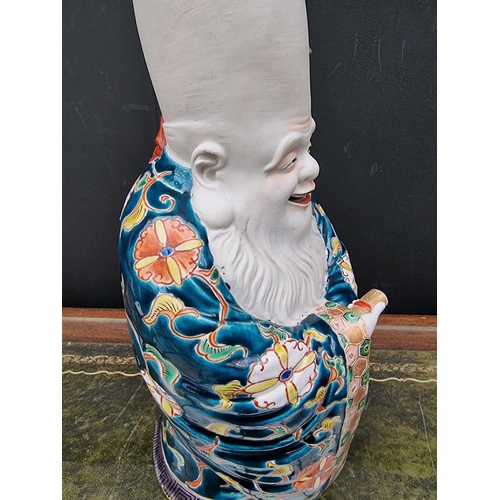 1671 - A large Japanese Kutani porcelain figure of Fukurokuju, 39cm high, (s.d).