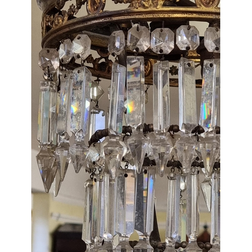 1678 - Two antique brass and facetted glass chandeliers, largest 65cm high.