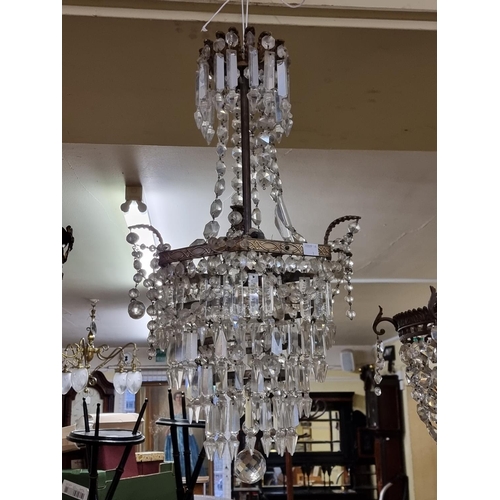 1678 - Two antique brass and facetted glass chandeliers, largest 65cm high.