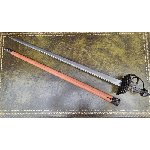 1703 - A reproduction basket hilt sword and leather scabbard, with 83cm blade.