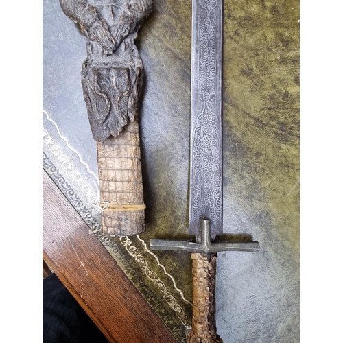 1714 - A Sudanese Mahdist Kaskara sword and crocodile scabbard, with etched 87cm blade, (loss to upper jaw)... 