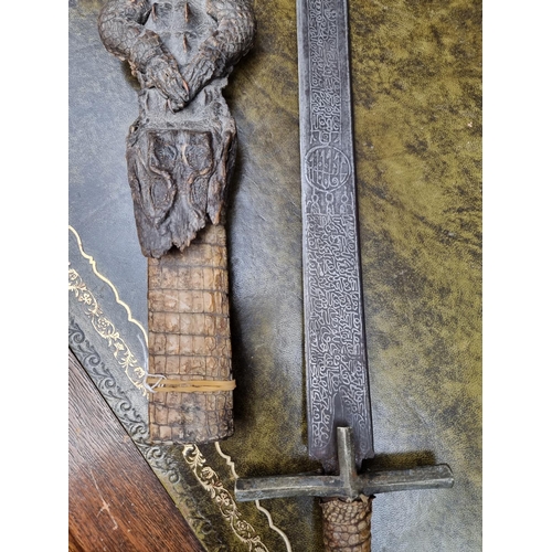 1714 - A Sudanese Mahdist Kaskara sword and crocodile scabbard, with etched 87cm blade, (loss to upper jaw)... 