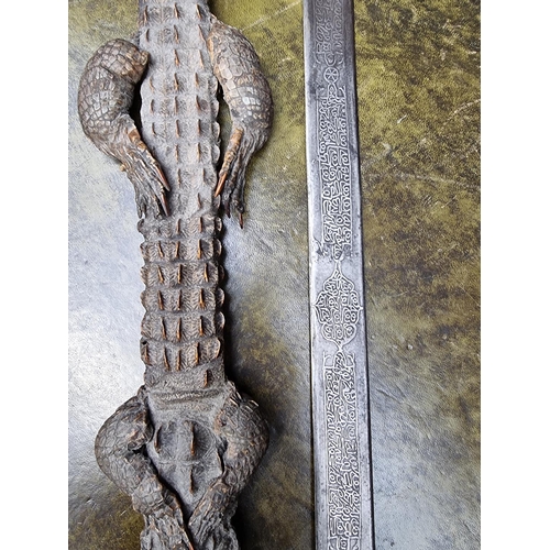 1714 - A Sudanese Mahdist Kaskara sword and crocodile scabbard, with etched 87cm blade, (loss to upper jaw)... 